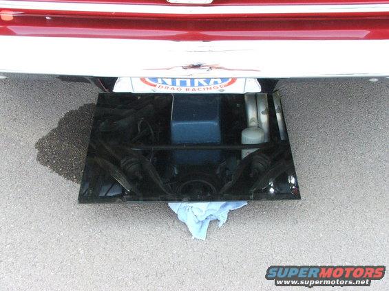 Underbody view of a car showing a license plate frame that says 'KINKS DRAG RACING'