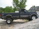 1979 Ford F-150 - Side view of a black Ford F-150 pickup truck with a toolbox in the bed.