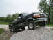 1979 Ford F-150 - This black pickup truck is shown from a 3/4 front angle, positioned on a pile of gravel.