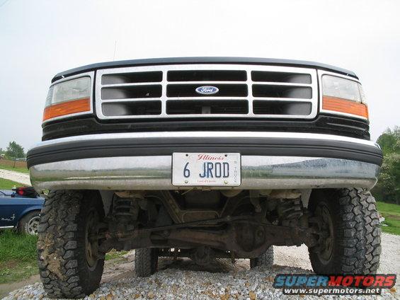 Front view of a Ford truck showing grille, headlights, bumper, and suspension components. Illinois license plate reads 6 JROD