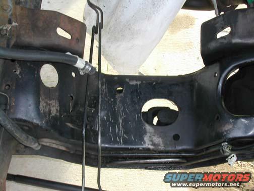 close-up of black metal frame with hoses and wires attached
