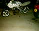1986 Honda Interceptor - A white 1986 Honda Interceptor motorcycle is parked next to a red vehicle.