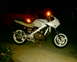 1986 Honda Interceptor - A white 1986 Honda Interceptor motorcycle is parked at night, showing its engine and exhaust system.