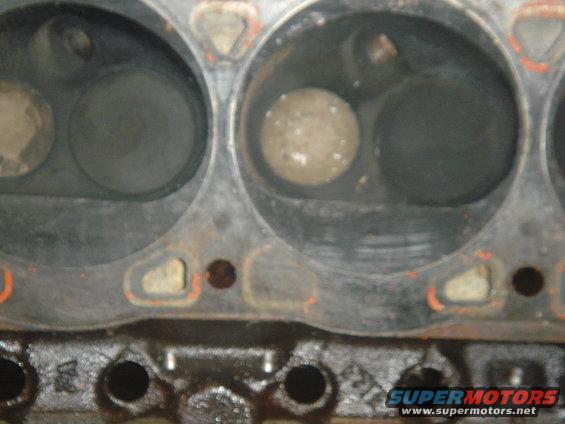 Engine cylinder heads with visible valves and carbon buildup