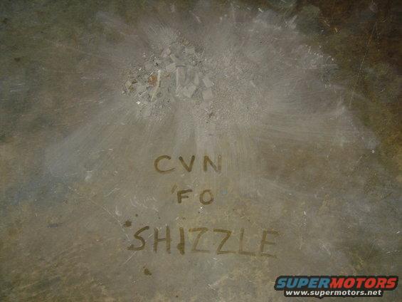 Metal surface with handwritten text CVN FO SHIZZLE and a Supermotors.net logo
