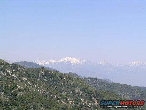 Mountain range with snow-capped peaks under a clear blue sky