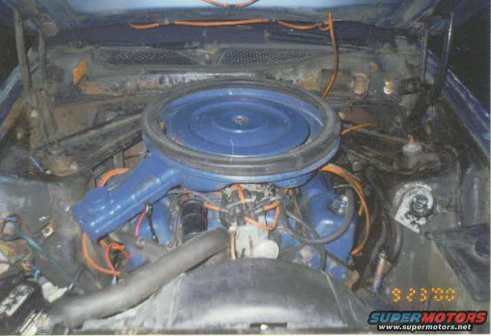 1972 Ford Mustang engine bay with blue air cleaner and orange wiring