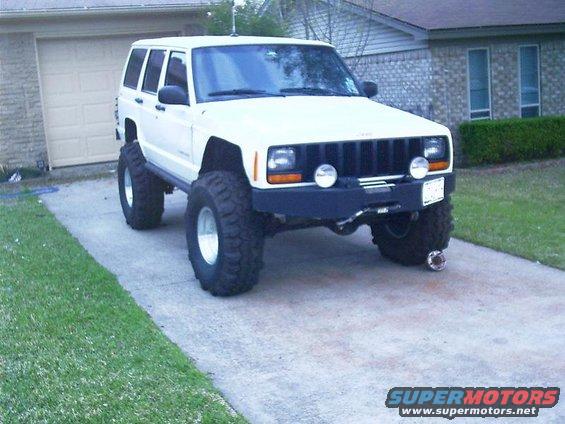 White lifted Jeep Cherokee XJ with large tires
