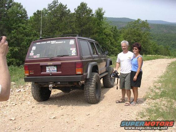 Maroon 1995 Jeep Cherokee rear view with lifted suspension and off-road tires