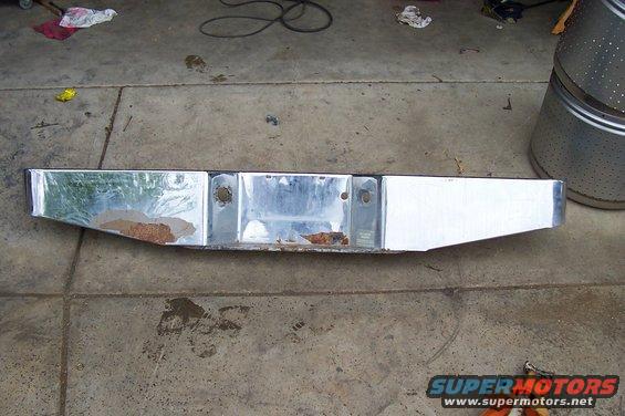 Chrome rear bumper with rust spots and license plate mounting holes