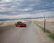 1996 Ford Probe - Red 1996 Ford Probe cruises down a desolate highway under a cloudy sky.