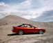 1996 Ford Probe - A 1996 Ford Probe sits in a dusty, arid landscape under a cloudy sky.