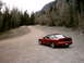 1996 Ford Probe - Red 1996 Ford Probe on a dirt road in a mountainous, wooded area.