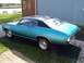 1971 Chevrolet Chevelle - A blue 1971 Chevrolet Chevelle coupe with a black roof is seen from the rear three-quarter angle next to a building.