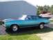 1971 Chevrolet Chevelle - This 1971 Chevrolet Chevelle coupe features a striking teal paint job and a contrasting black vinyl roof, seen parked outdoors.