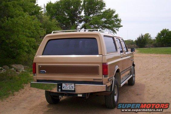 Tan SUV with wood paneling, rear view. License plate WSS-52K