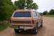 1988 Ford C-350 (Centurion Conversions) - This tan SUV features wood paneling on its rear and a roof rack. The license plate reads WSS-52K.