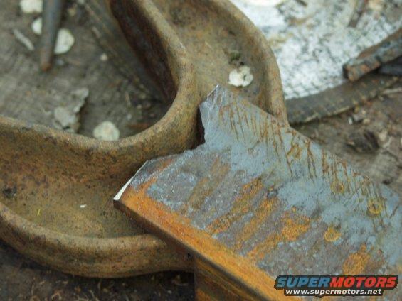Close-up of a rusted metal part with a broken edge