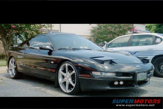 Black 1995 Ford Probe with pop-up headlights and custom wheels