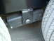 1979 Ford Bronco - Close-up view of a trailer's suspension system, showing a bracket and a tire.