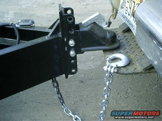 trailer hitch assembly with safety chains attached to a vehicle bumper