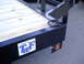 1979 Ford Bronco - Close-up of a trailer deck and frame, showing the TWF Mfg. logo and a D-ring tie-down point.