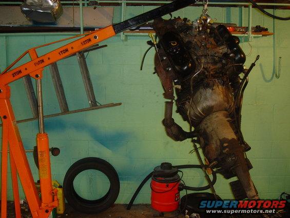 Engine and transmission assembly suspended by an engine hoist