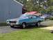 1971 Chevrolet Chevelle - This 1971 Chevrolet Chevelle coupe features a distinctive matte black hood stripe and a black vinyl roof, parked in a residential driveway.