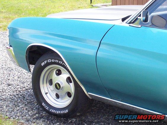 side view of a blue classic car with BFGoodrich tires and chrome trim