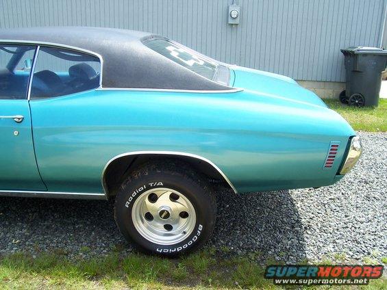 1971 Chevrolet Chevelle rear quarter panel, teal coupe with black vinyl top and chrome trim