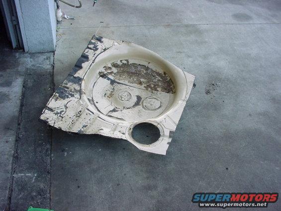 Spare tire well liner with circular indentations and a speaker cutout