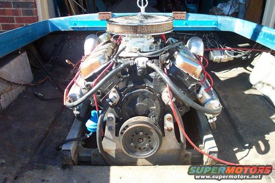 Boat engine with chrome valve covers and air filter, viewed from above