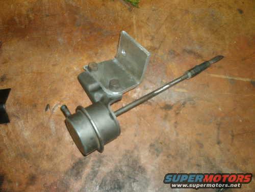 Turbocharger wastegate actuator on a wooden surface