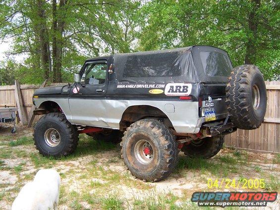 Lifted Ford Bronco with soft top, large tires, and ARB sticker on the side