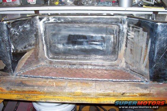 Custom metal bumper with diamond plate insert and welded seams, showing signs of fabrication