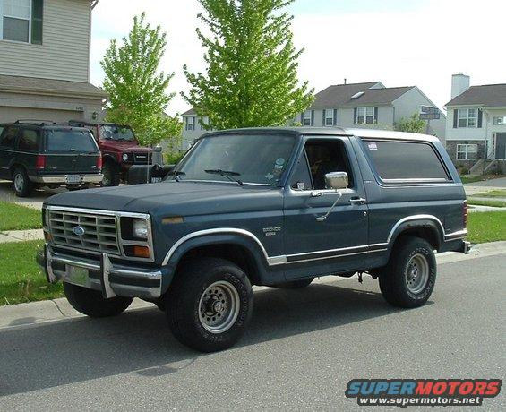 Dark blue 1982 Ford Bronco parked curbside, three-quarter front view
