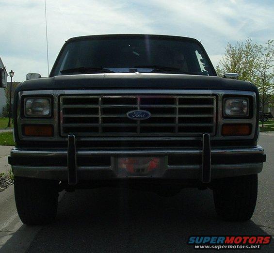 Black Ford Bronco front view. Grille has horizontal bars and a blue Ford emblem. Square headlights