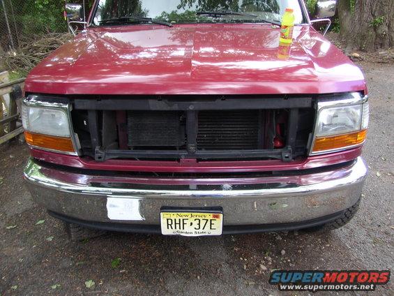 Red truck front end, missing grille, 1995 Ford Bronco
