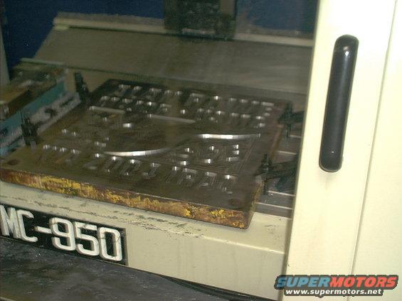 Metal stamping die with raised lettering, labeled MC-950