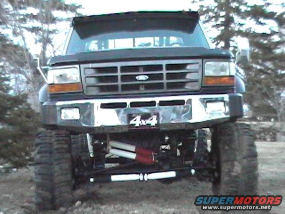 Front view of black Ford F-series truck with 4x4 badge and large tires