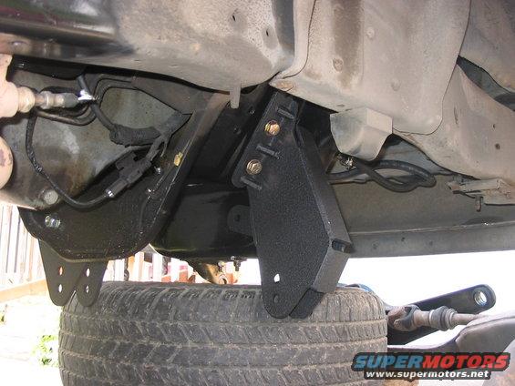 Undercarriage view of lift kit brackets and suspension components
