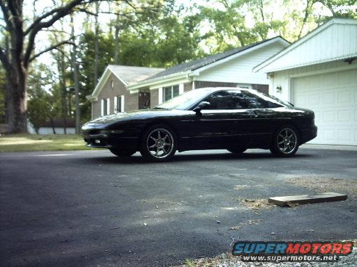 Black 1995 Ford Probe parked in driveway, side view