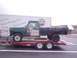 1979 Ford Bronco - A Ford F-Series pickup truck is being transported on a red trailer.