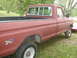 1979 Ford Bronco - Side view of a red pickup truck, likely a 1979 Ford F-Series, parked on grass.