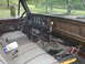 1979 Ford Bronco - The interior of this truck features a wood-grain trim panel on the dashboard and a patterned fabric seat.