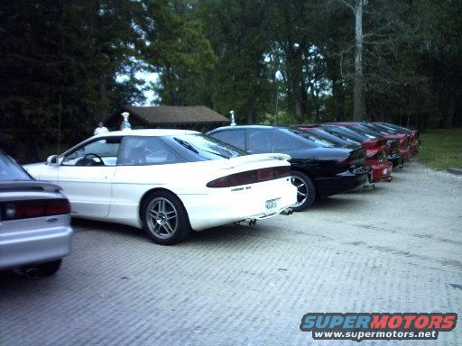 Several Ford Probes parked in a row, white one in foreground