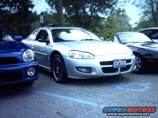 Silver coupe with blue license plate reading 'MEGNS RT'