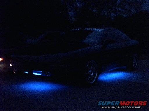 Car with blue underglow lighting at night. Text on windshield reads 'TEAM PROBE'