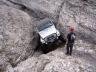 White SUV navigating a rocky ravine