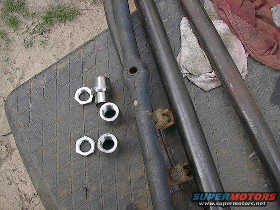 Tie rod ends and nuts on a textured surface